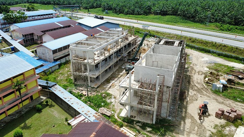 Aerial view of a three-storey block with roof slab being cast